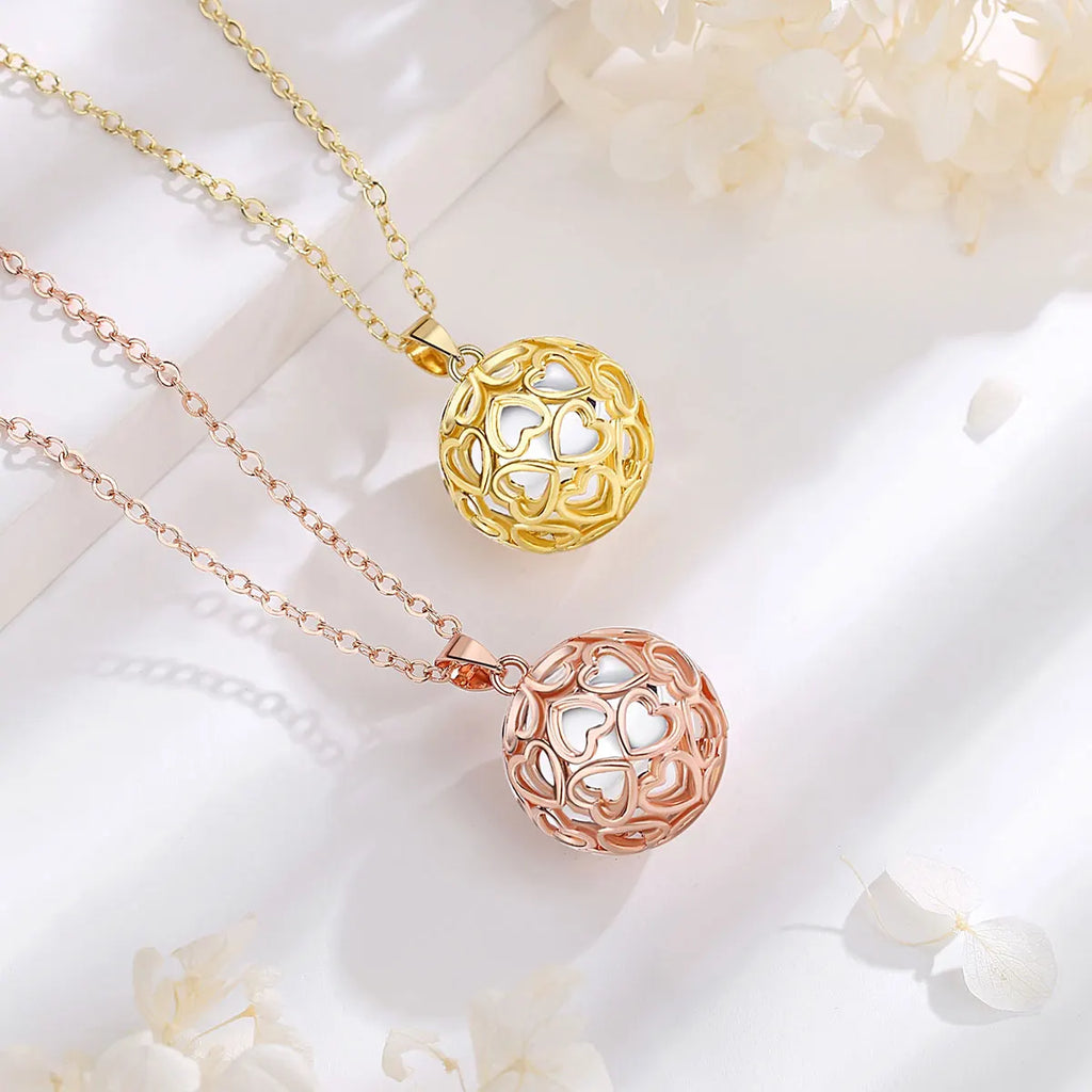 Bolas de grossesse cœur ajouré doré et or rose sur leurs chaînes
